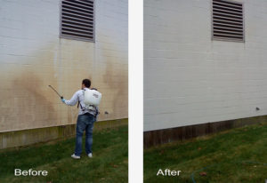 Champion Cleaning power washing rust off a building