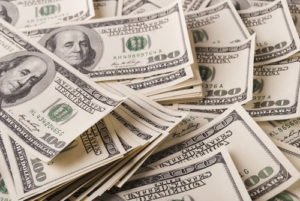 American 100 dollar bills that symbolize rising minimum wage in New England